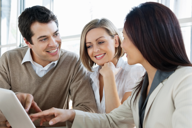 Couple with a Loan Officer in front of a laptop