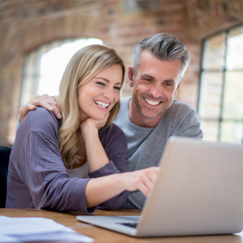 Couple in front of a laptop
